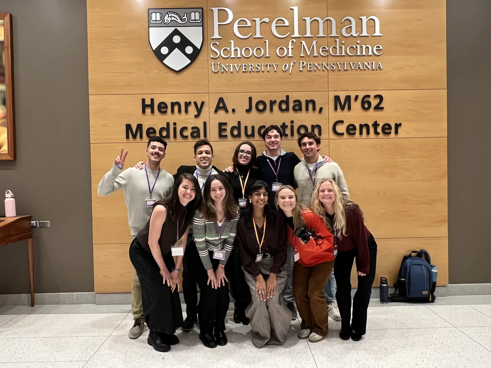 IPN members posing together in front of the University of Pennsylvania Perelman School of Medicine sign